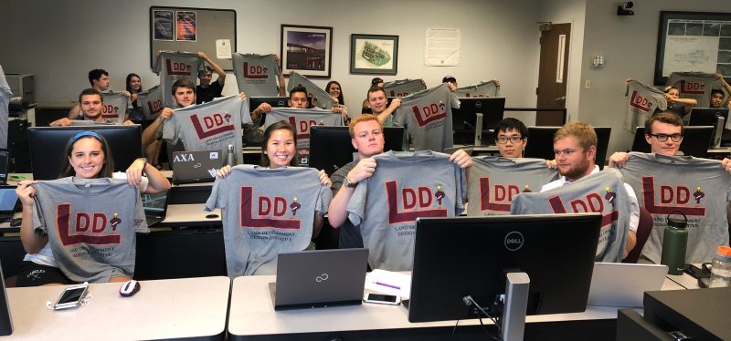 students holding up LDDI tshirts